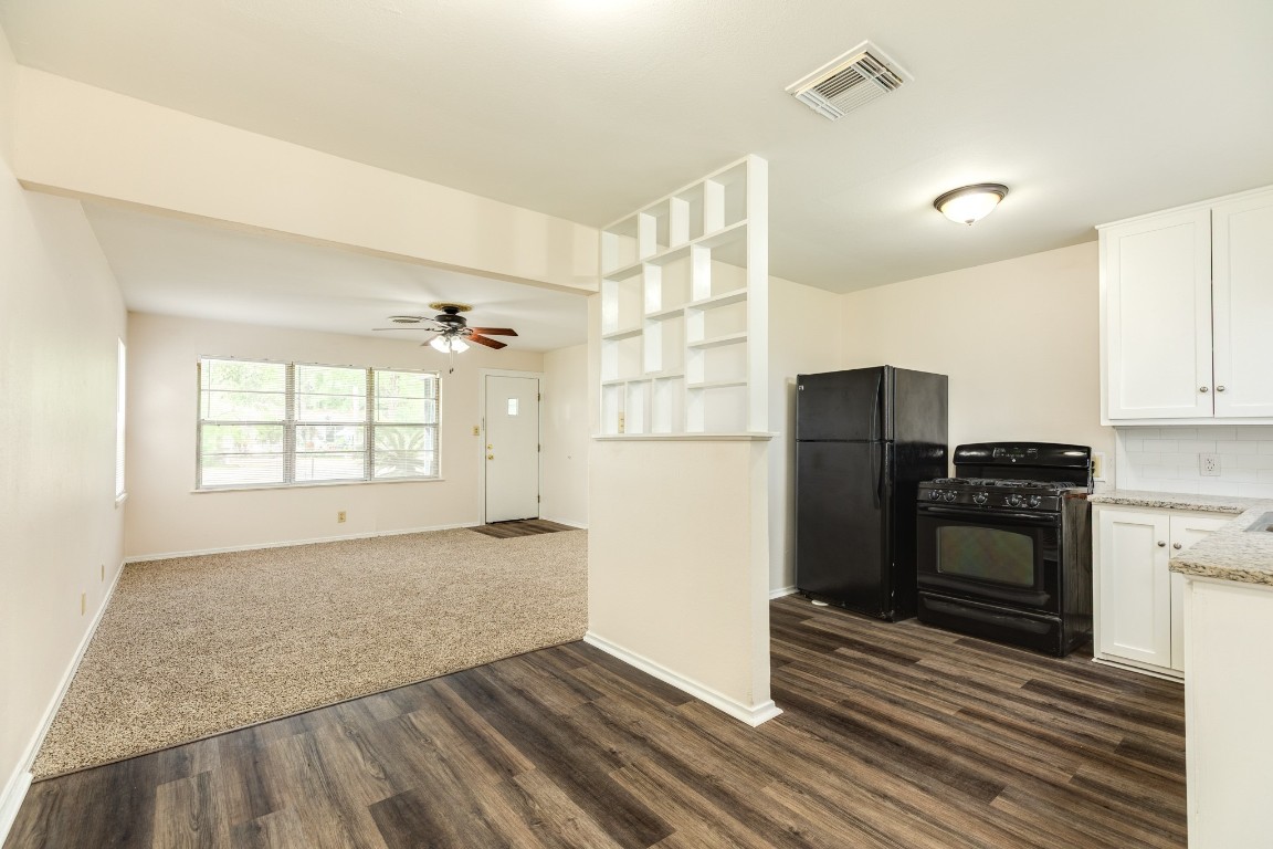 837 Pin Money Street Clute, TX 77531 - Photo 15 of 24 a view of a kitchen with wooden cabinet and a refrigerator