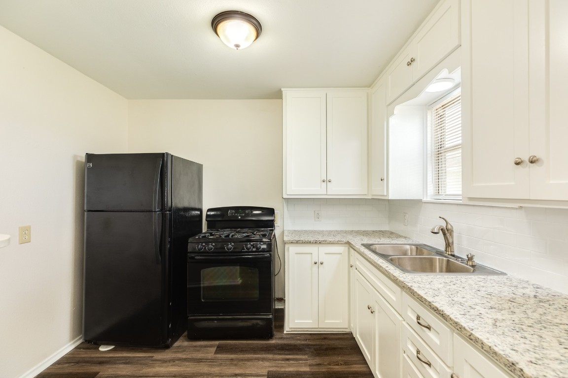 837 Pin Money Street Clute, TX 77531 - Photo 16 of 24 a kitchen with a sink stove and refrigerator
