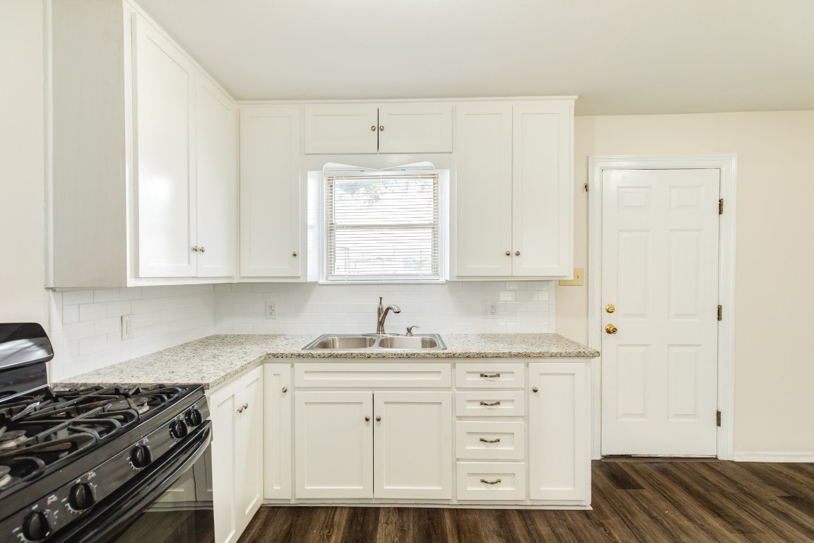 837 Pin Money Street Clute, TX 77531 - Photo 17 of 24 a kitchen with granite countertop white cabinets and white appliances