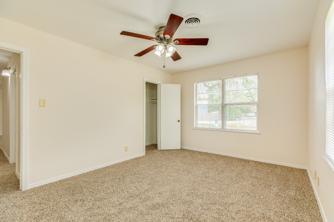 837 Pin Money Street Clute, TX 77531 - Photo 19 of 24 an empty room with ceiling fan and window