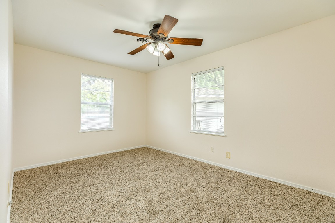 837 Pin Money Street Clute, TX 77531 - Photo 20 of 24 an empty room with windows and fan