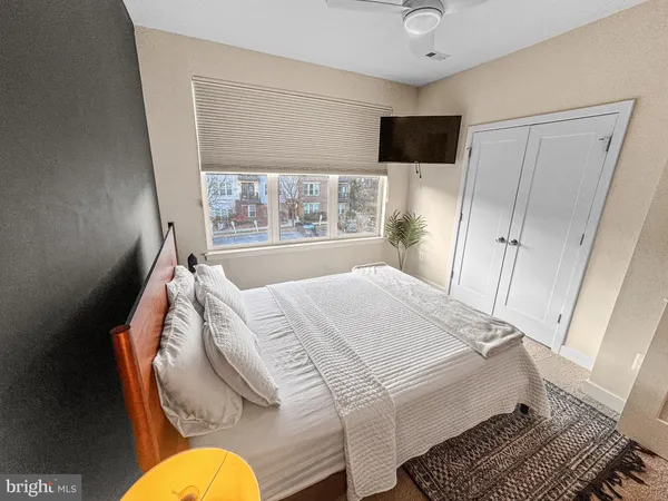 a bed room with a bed and a television