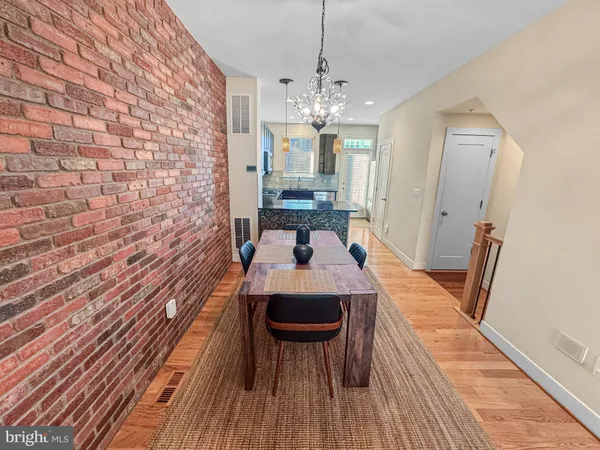 a view of a livingroom with furniture wooden floor and chandelier