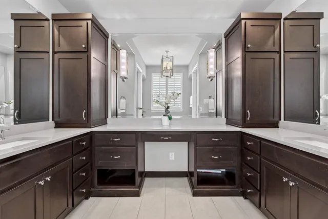 a spacious bathroom with a granite countertop sink and a mirror