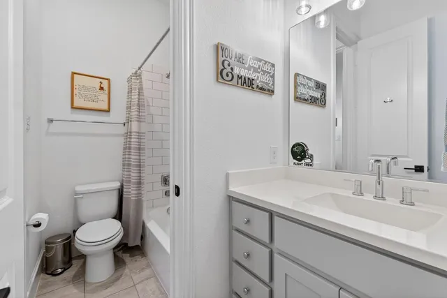a bathroom with a toilet sink and shower