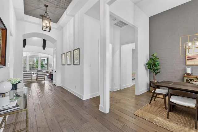 a view of a livingroom with furniture a ceiling fan and wooden floor