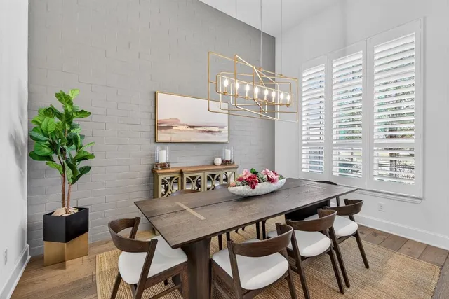 a view of a dining room with furniture and a potted plant