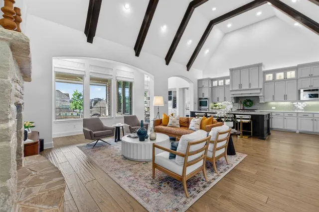 a living room with lots of furniture and kitchen view