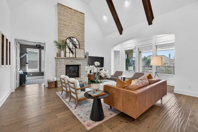 a living room with fireplace furniture and a wooden floor
