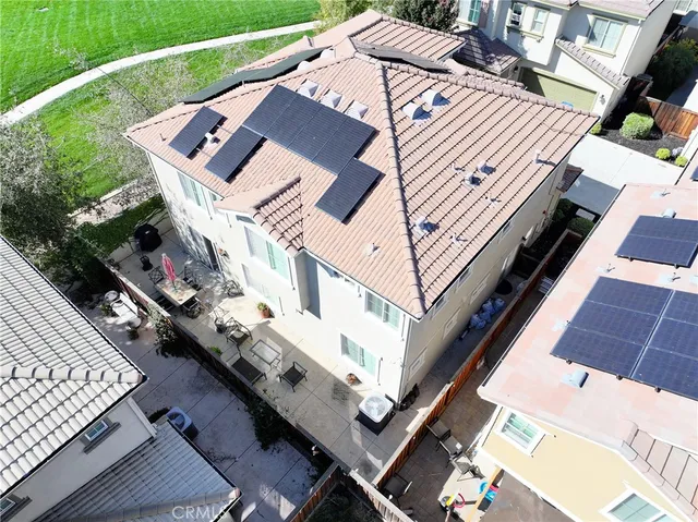 a roof deck with table and chairs