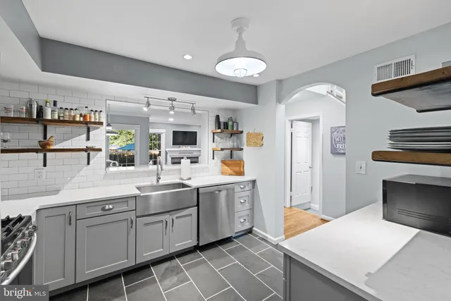 a kitchen with stainless steel appliances a sink and stove