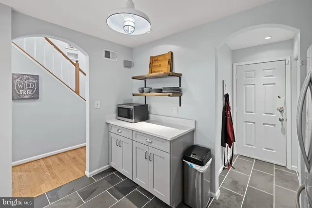 a utility room with cabinets washer and dryer