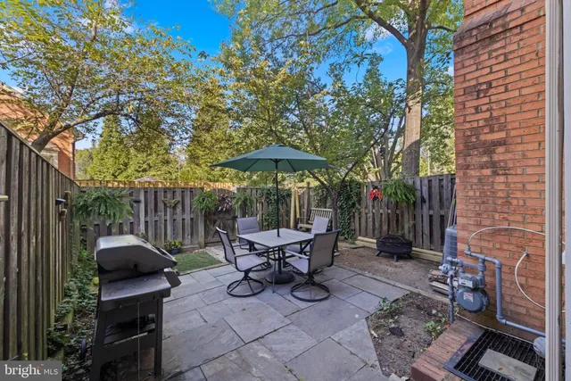 a view of a patio with chairs and a fire pit