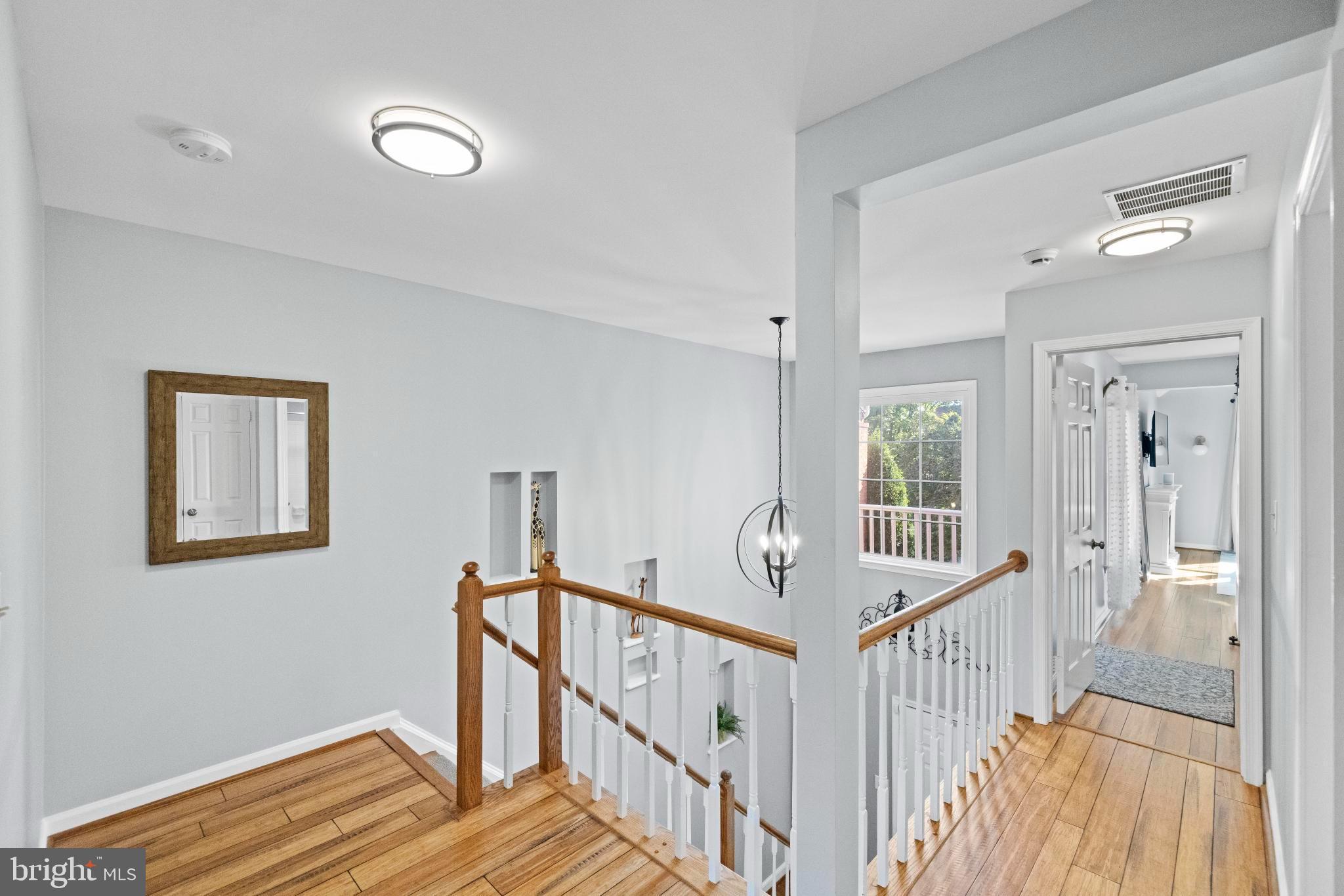 1792 Duffield Lane Alexandria, VA 22307 - Photo 20 of 50 a view of a hallway with wooden floor and windows