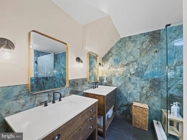 a bathroom with a sink vanity granite and a mirror