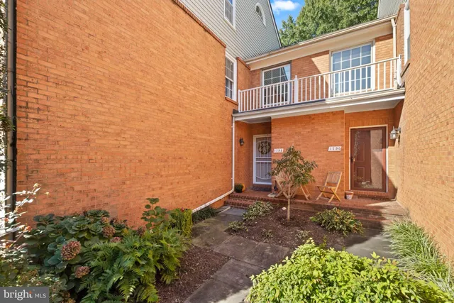a front view of a house with plants