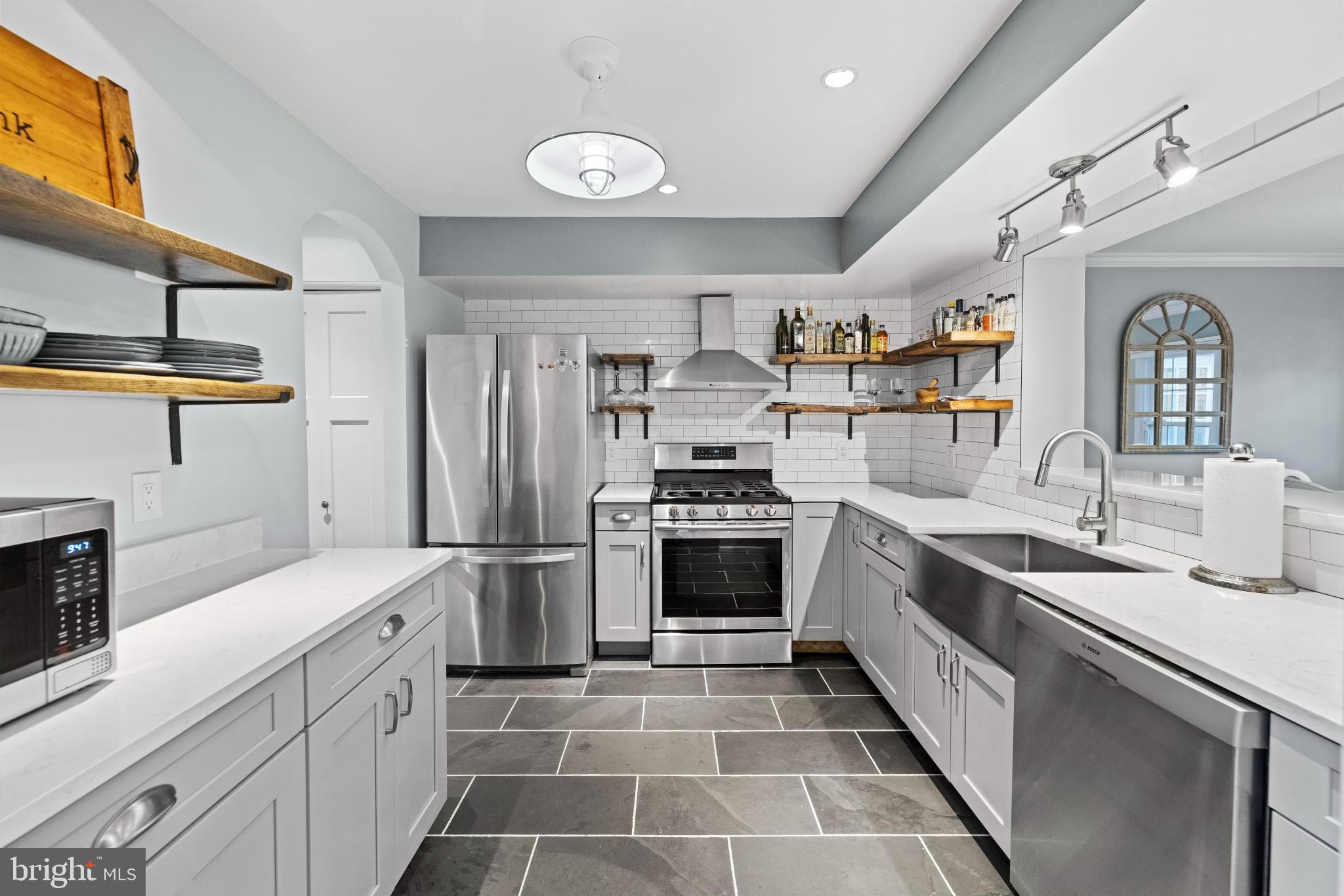 1792 Duffield Lane Alexandria, VA 22307 - Photo 9 of 50 a kitchen with stainless steel appliances granite countertop a sink and stove top oven