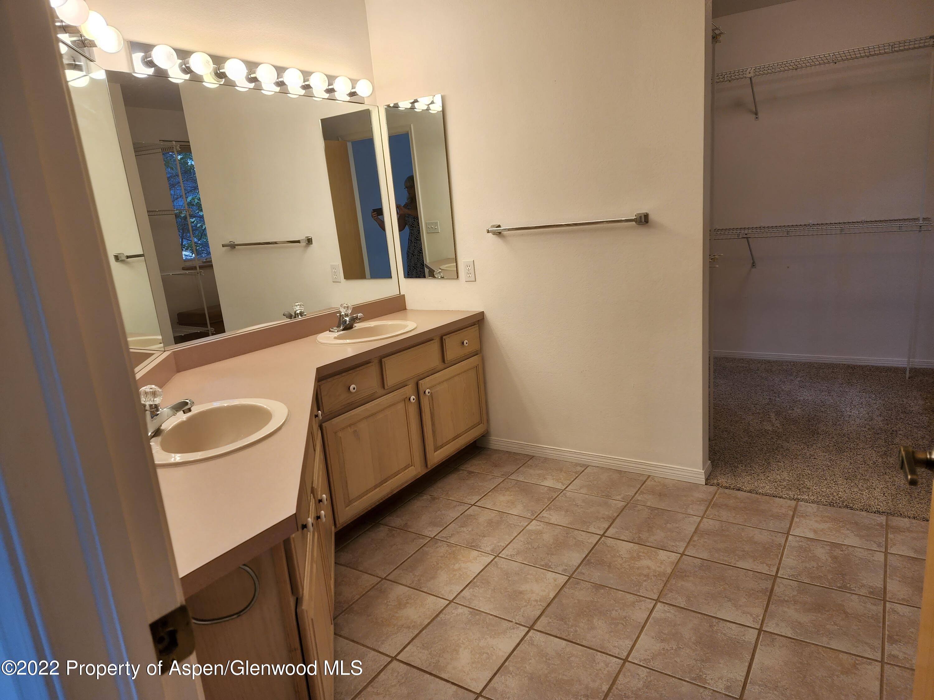 751 Latigo Loop Carbondale, CO 81623 - Photo 25 of 44 a bathroom with a sink a mirror and a shower