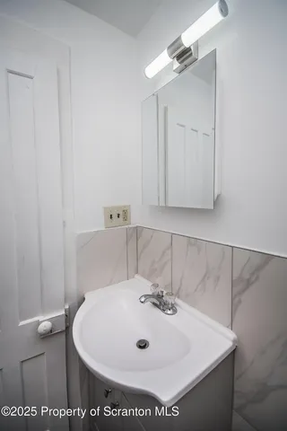 a bathroom with a sink and mirror