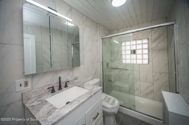 a bathroom with a sink toilet and shower