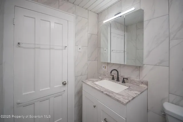 a bathroom with a sink and vanity