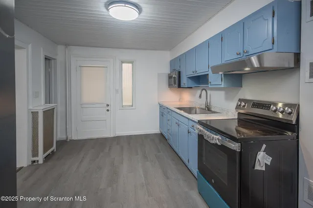 a kitchen with wooden cabinets and a stove