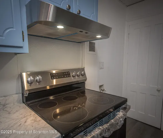 a stove top oven sitting inside of a kitchen