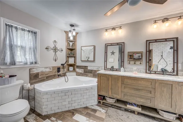 a bathroom with a tub sink and mirror