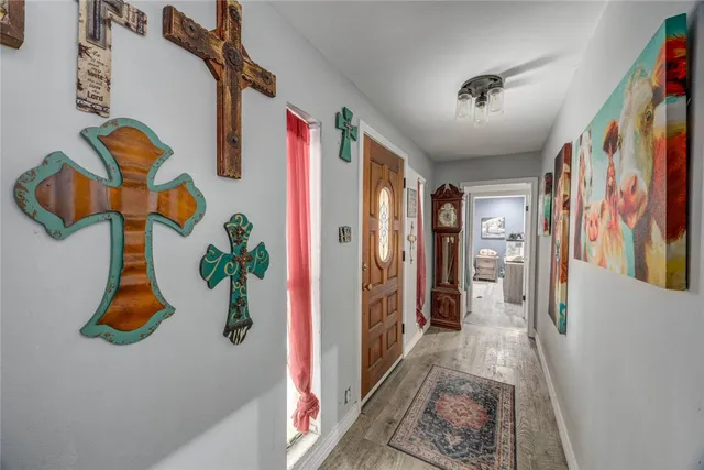 a view of an entryway with wooden floor