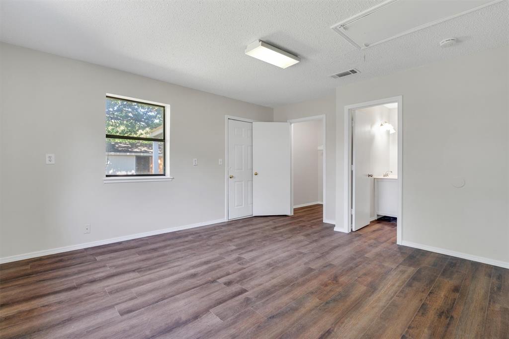 209 Mistletoe Lane Keene, TX 76059 - Photo 23 of 38 a view of an empty room with wooden floor and a window
