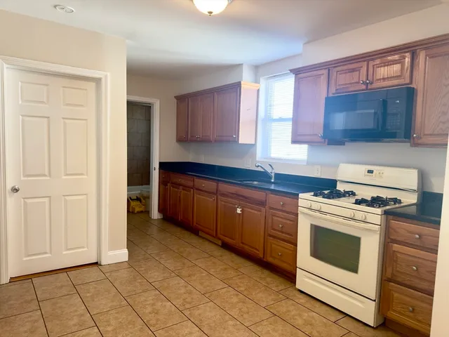 a kitchen with a stove top oven sink and cabinets