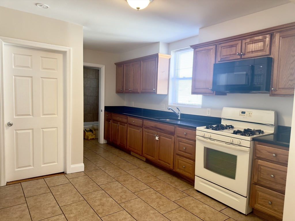 a kitchen with a stove top oven sink and cabinets