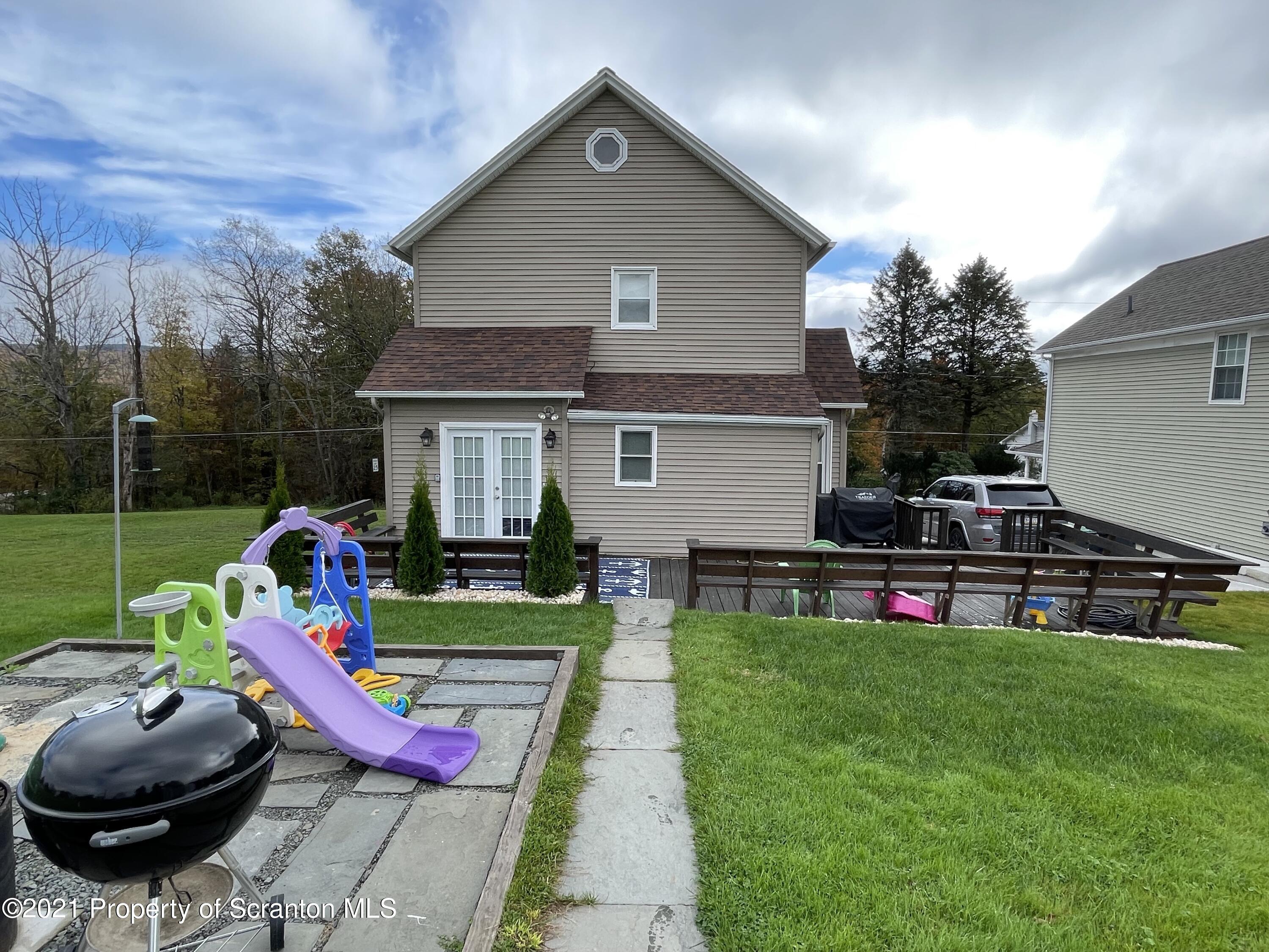 425 Clinton Street Vandling, PA 18421 - Photo 31 of 32 a view of backyard with swimming pool and seating space