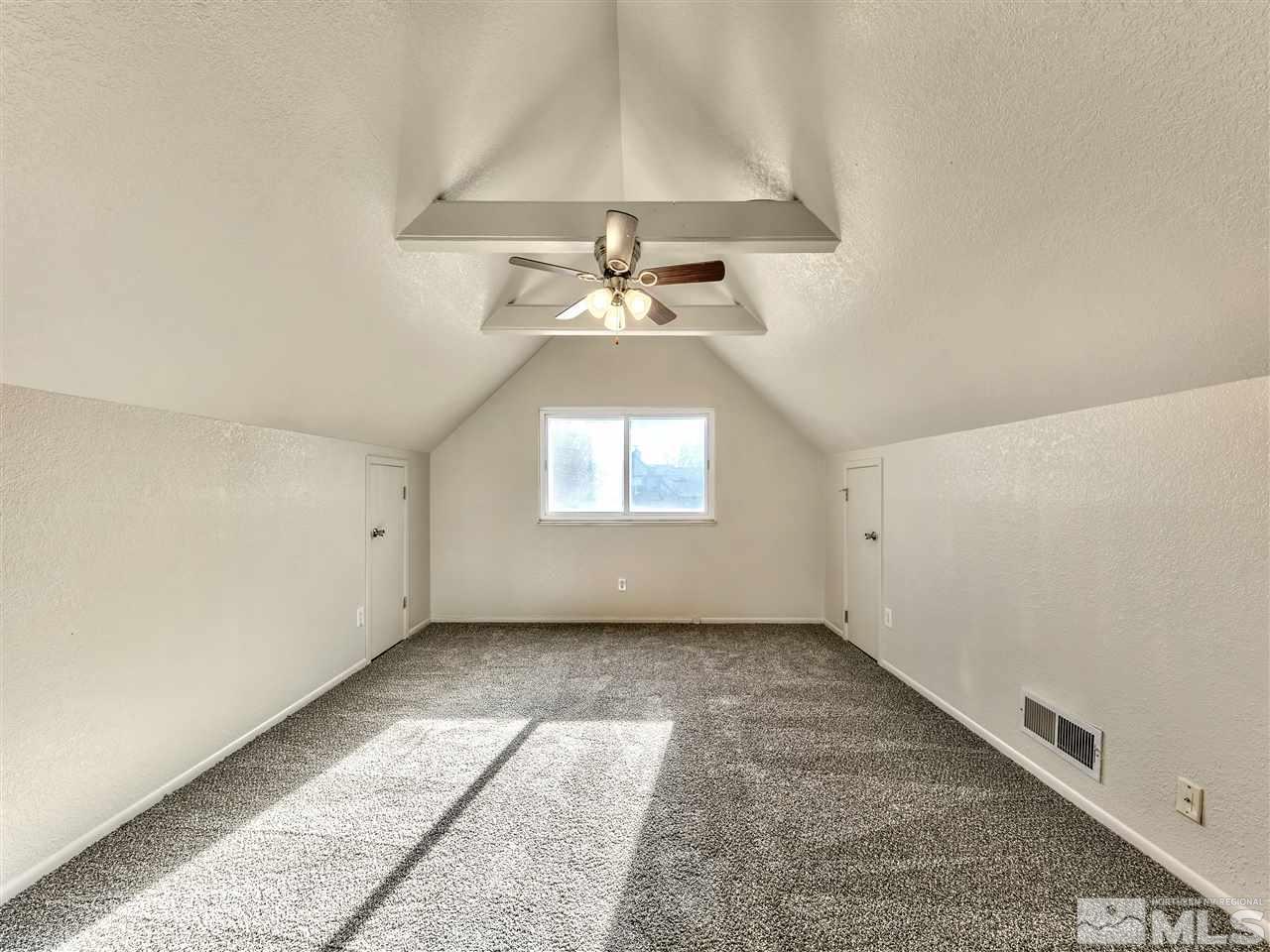 7460 Berryhill Drive Reno, NV 89511 - Photo 20 of 23 an empty room with a window and chandelier fan