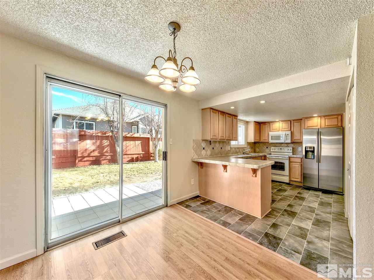 7460 Berryhill Drive Reno, NV 89511 - Photo 9 of 23 a view of a kitchen with a stove cabinets and a floor to ceiling window