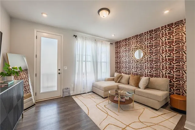 a living room with furniture and wooden floor