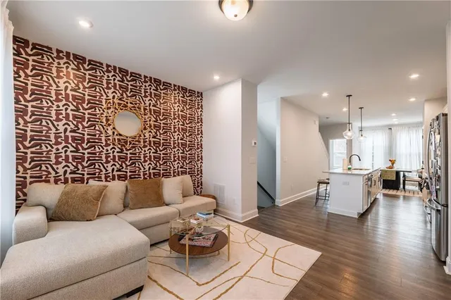 a living room with furniture and wooden floor