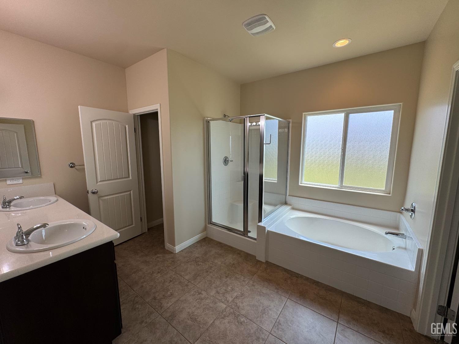 Undisclosed Address Bakersfield, CA 93313 - Photo 13 of 16 a bathroom with a tub sink shower and mirror