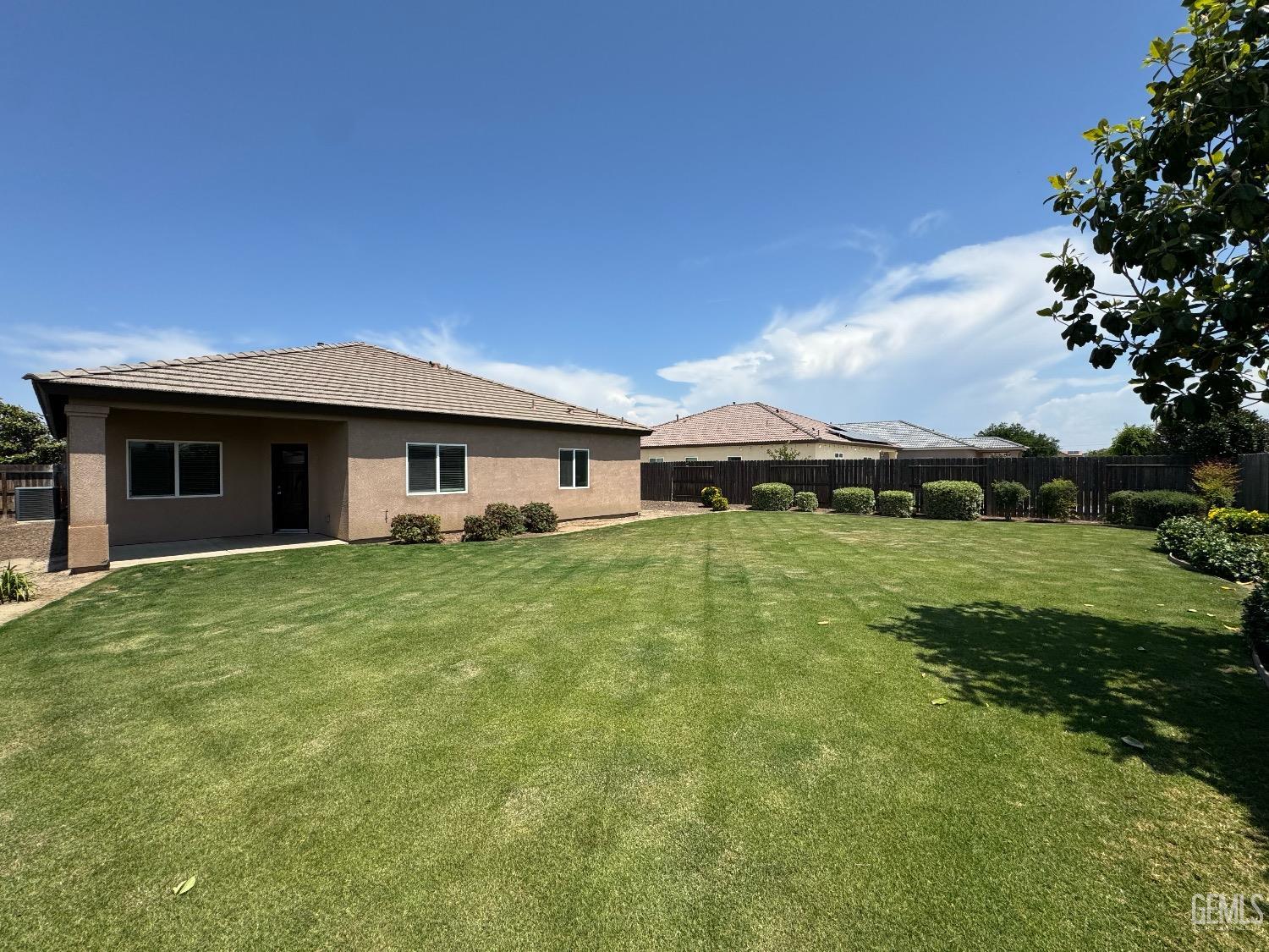 Undisclosed Address Bakersfield, CA 93313 - Photo 16 of 16 a front view of a house with a garden