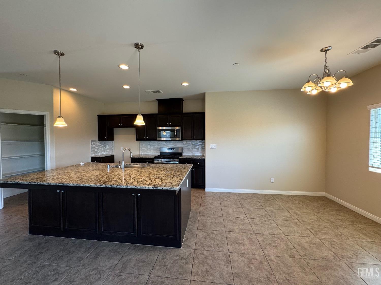 Undisclosed Address Bakersfield, CA 93313 - Photo 2 of 16 a large kitchen with a counter space a sink and dishwasher