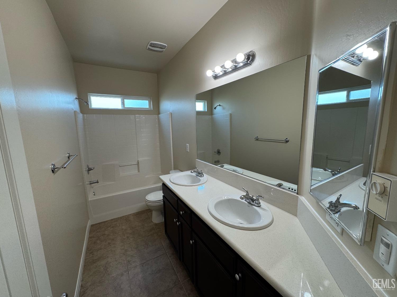 Undisclosed Address Bakersfield, CA 93313 - Photo 9 of 16 a bathroom with a sink double vanity and a mirror