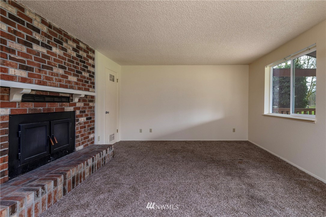 7456 Riverside Drive East Sumner, WA 98390 - Photo 12 of 40 a view of empty room with a fireplace