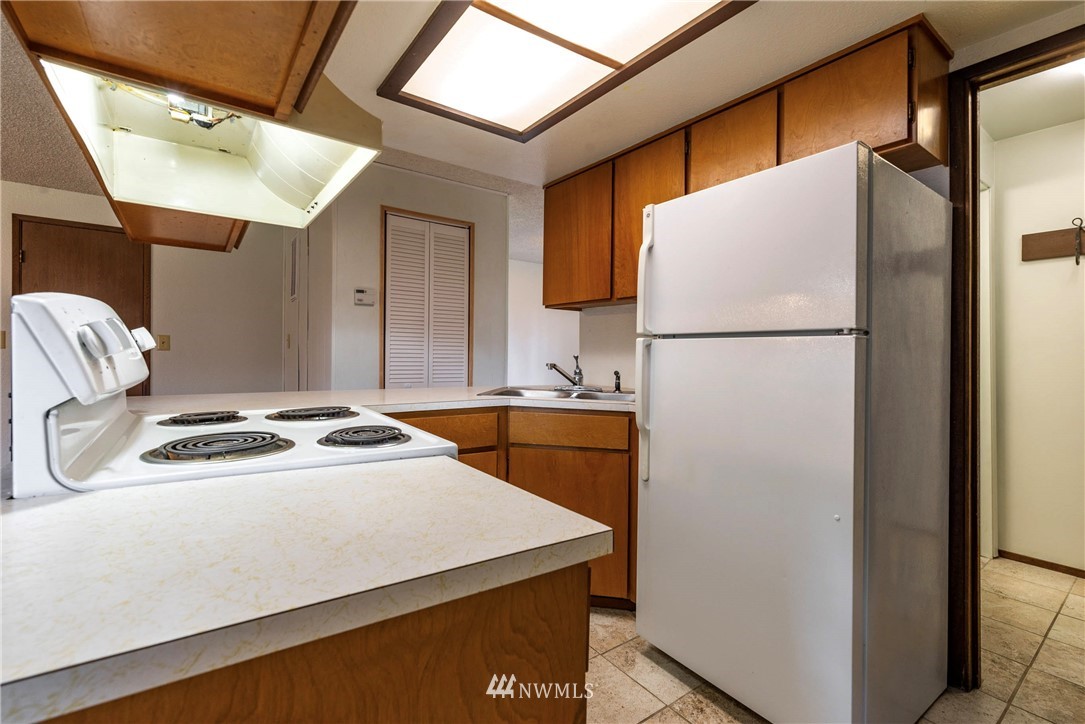 7456 Riverside Drive East Sumner, WA 98390 - Photo 25 of 40 a white refrigerator freezer sitting inside of a kitchen