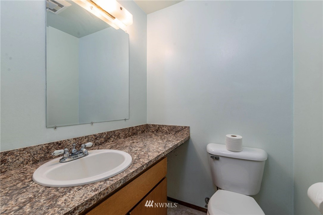 7456 Riverside Drive East Sumner, WA 98390 - Photo 28 of 40 a bathroom with a granite countertop sink and a toilet