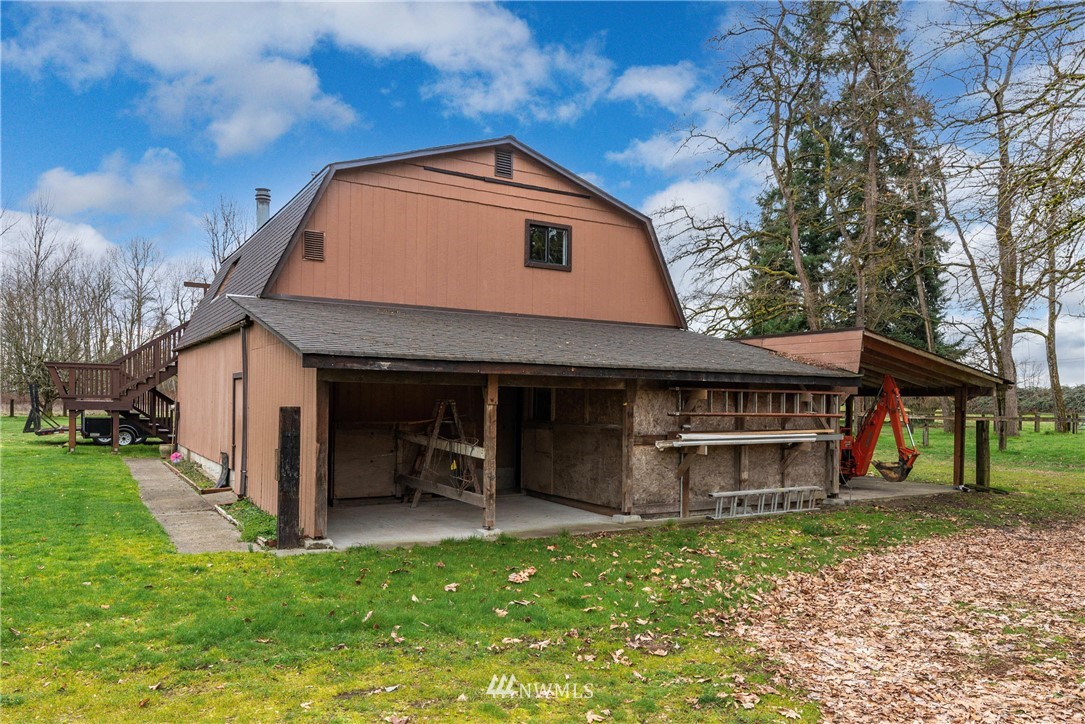 7456 Riverside Drive East Sumner, WA 98390 - Photo 32 of 40 a front view of a house with a garden and deck