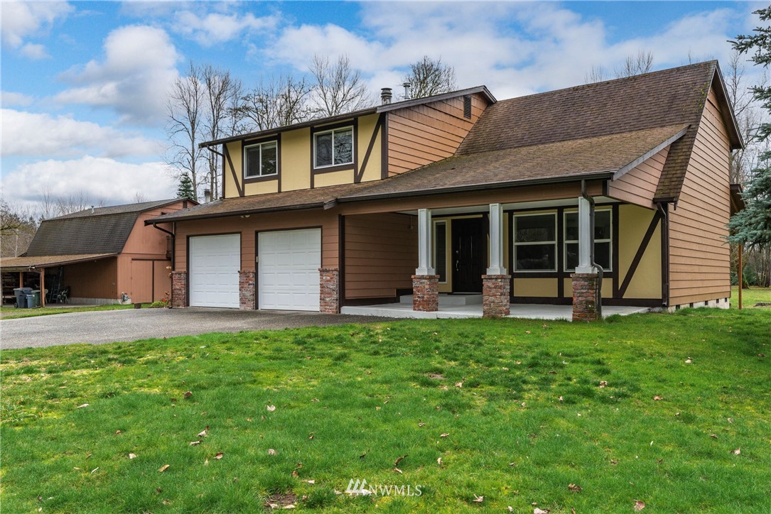 7456 Riverside Drive East Sumner, WA 98390 - Photo 5 of 40 front view of a house with a yard