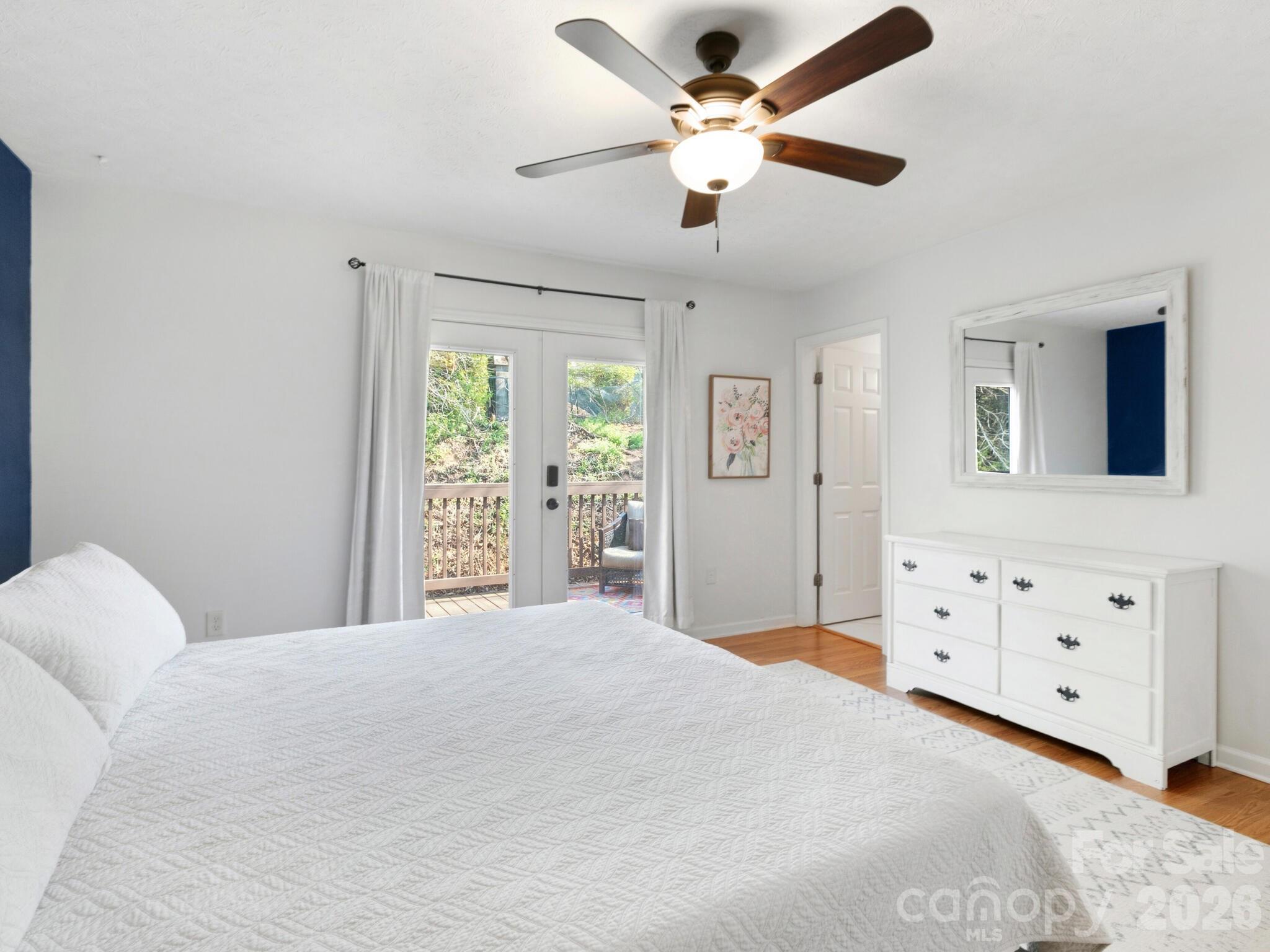 1 Mosers Place Candler, NC 28715 - Photo 18 of 32 a bedroom with a large bed and a chandelier fan