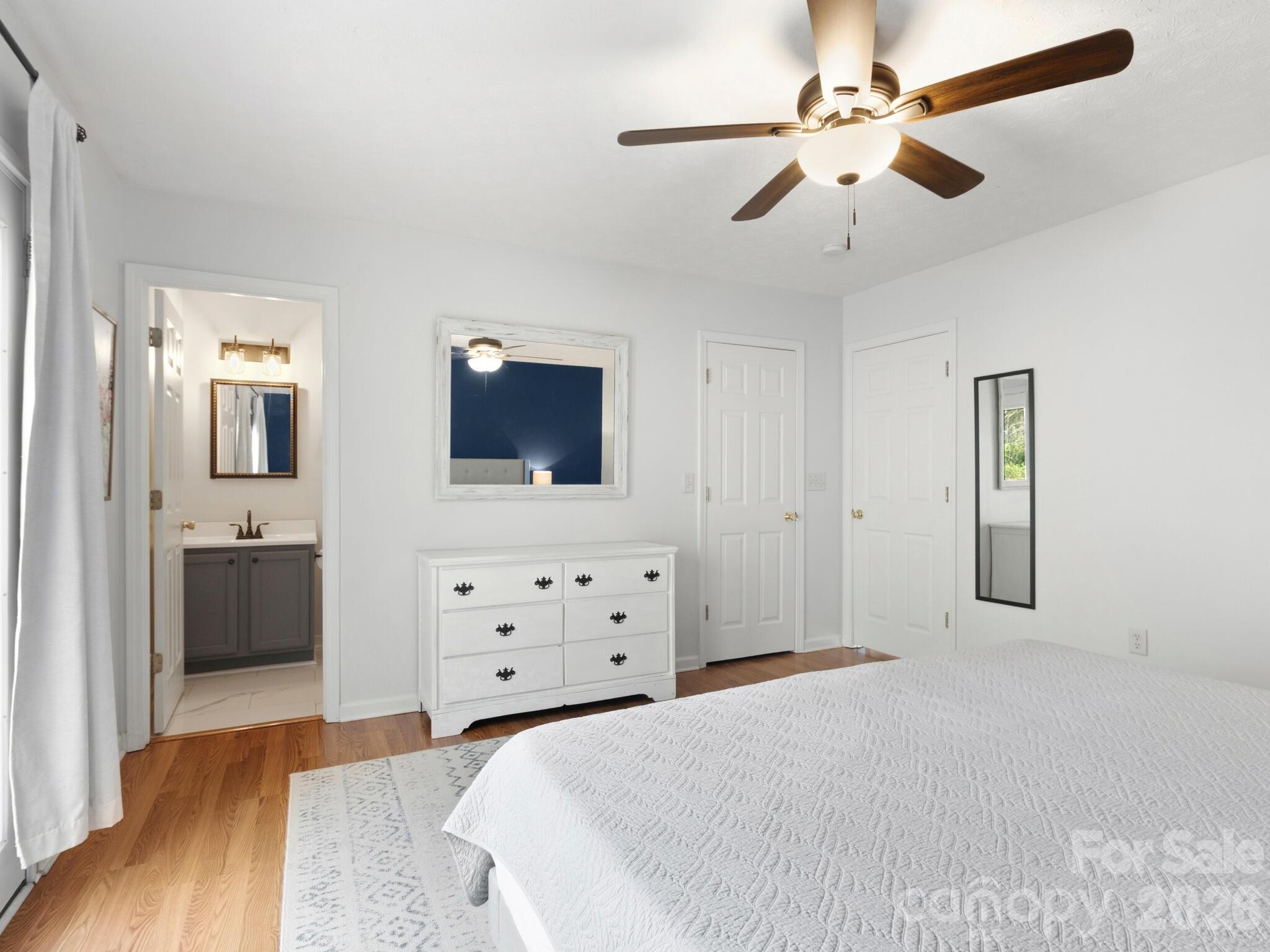 1 Mosers Place Candler, NC 28715 - Photo 19 of 32 a bedroom with a bed and a flat tv screen on dresser