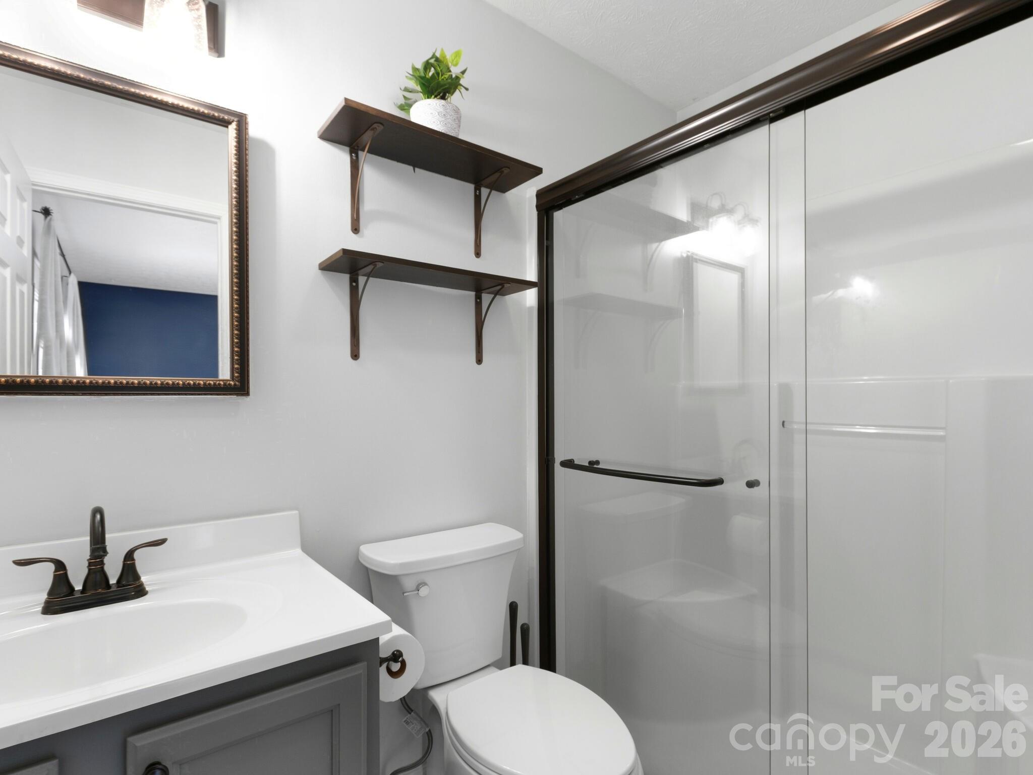 1 Mosers Place Candler, NC 28715 - Photo 20 of 32 a bathroom with a sink toilet and shower