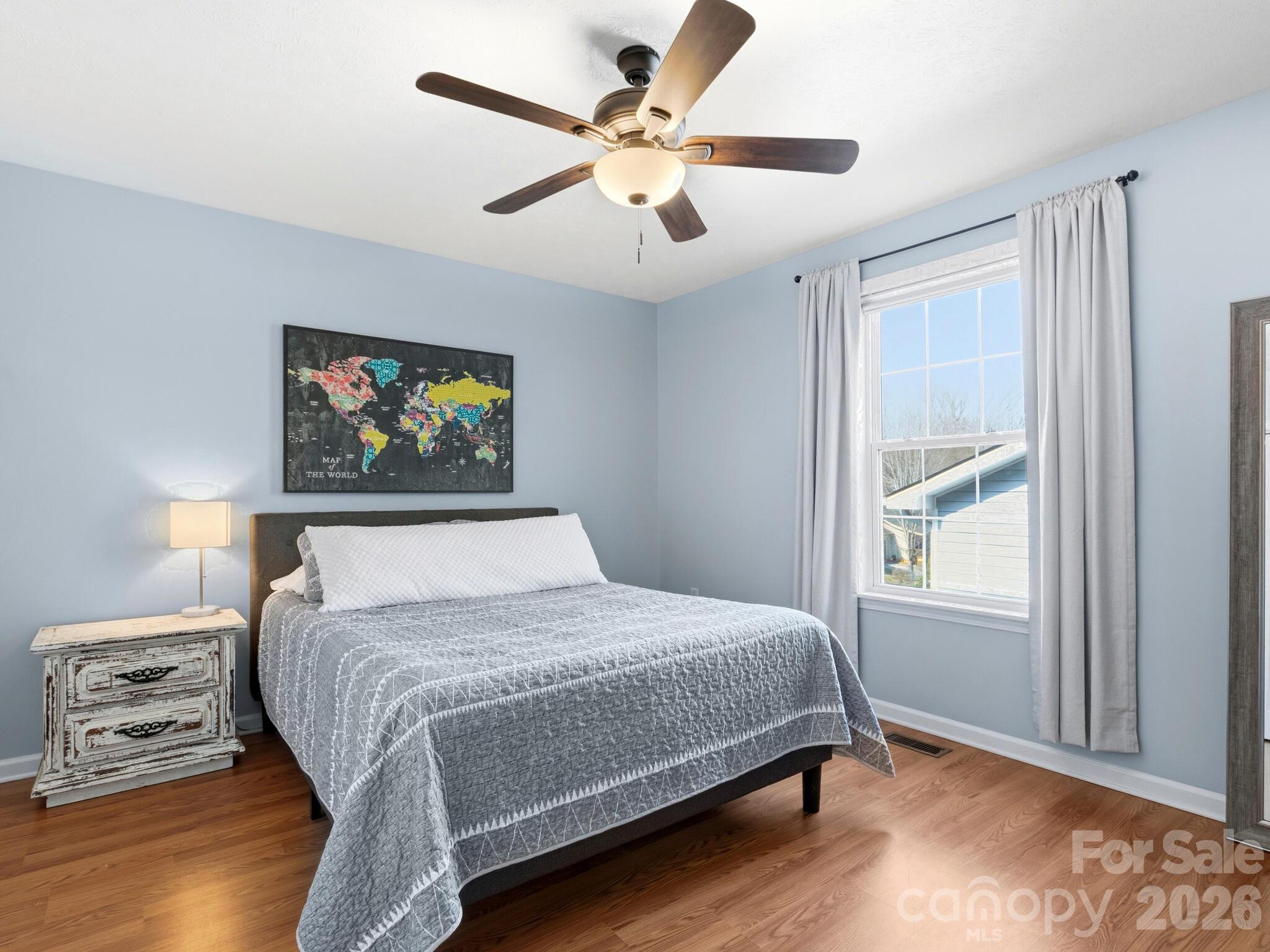 1 Mosers Place Candler, NC 28715 - Photo 21 of 32 a bedroom with a bed and a painting on the wall